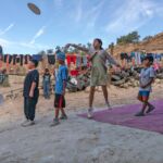 Migrant children throwing a disc at a shelter in Tijuana
